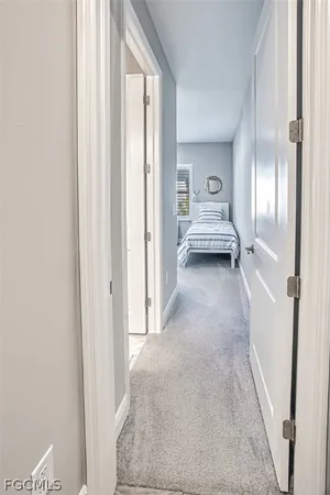 a view of a hallway with wooden floor and windows