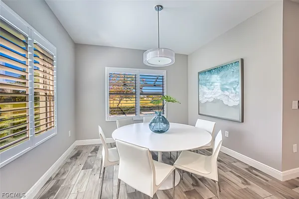 a view of a dining room with furniture window and wooden floor