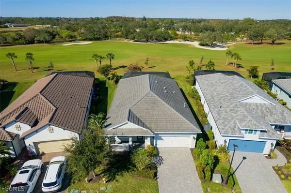 an aerial view of a house with garden space and ocean view