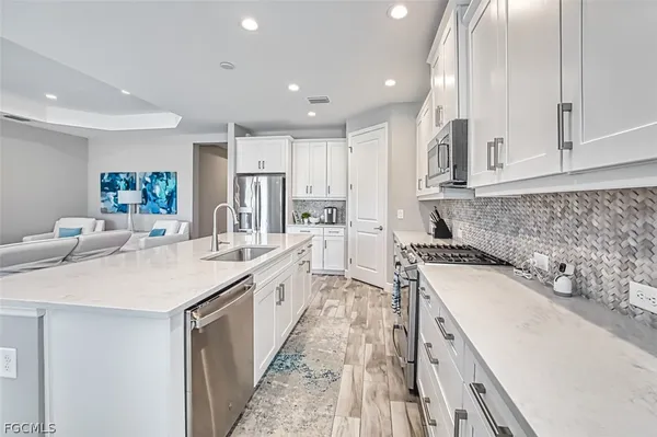 a kitchen with a sink stove and cabinets
