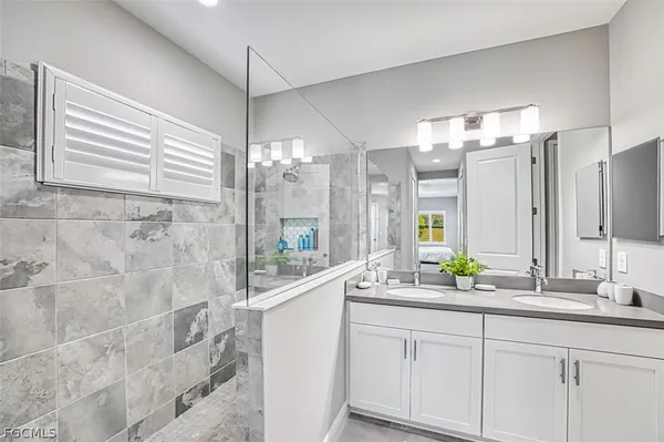 a bathroom with a double vanity sink and a mirror