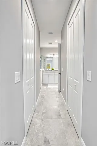 a view of a hallway with a cabinet and a mirror