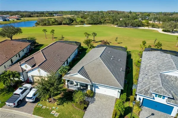 an aerial view of residential houses with outdoor space and ocean