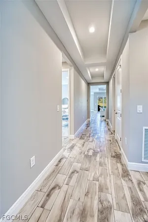 a big room with wooden floor and windows