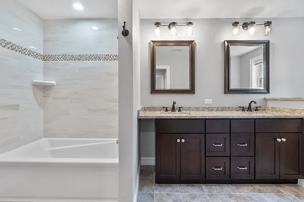 a bathroom with a double vanity sink and mirror