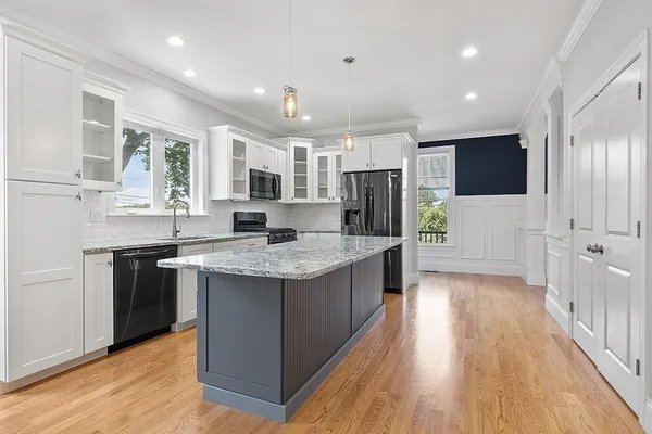 a kitchen with stainless steel appliances granite countertop a sink stove and refrigerator