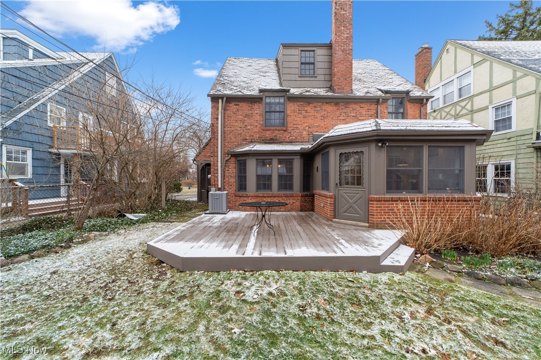 17027 Fernway Road Cleveland, OH 44120 - Photo 36 of 42 Rear view of house with central AC unit, a high end roof, a chimney, a deck, and brick siding