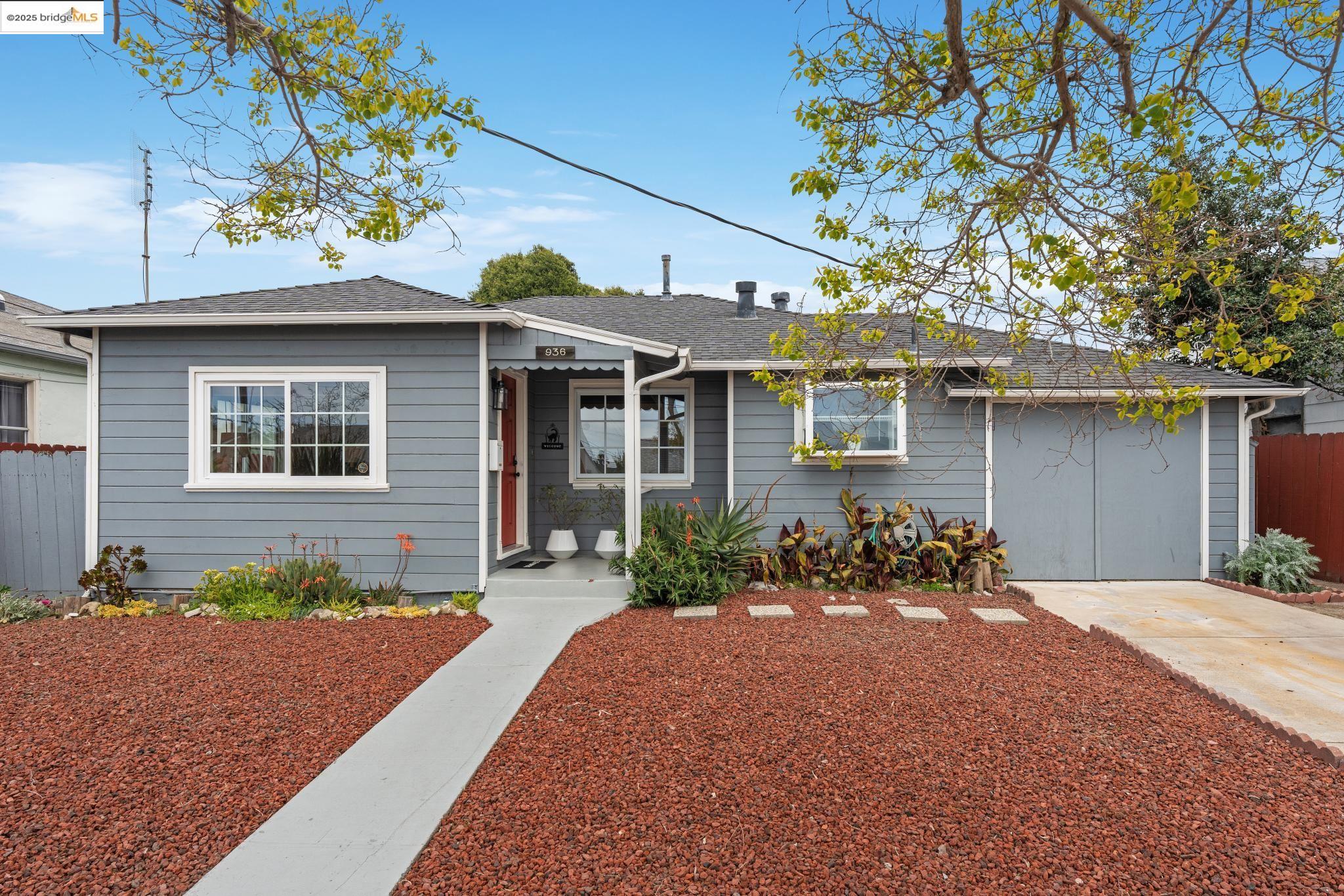 a front view of a house with a yard and outdoor seating