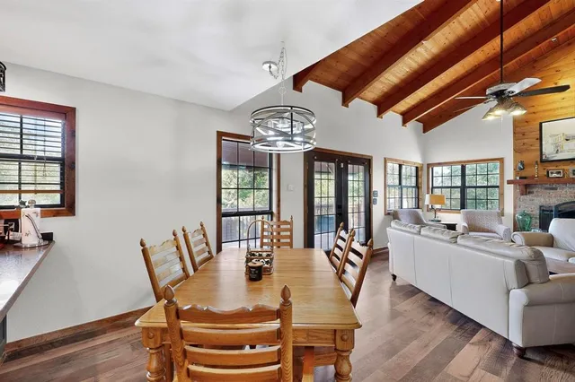 a living room with furniture a large window and a fireplace