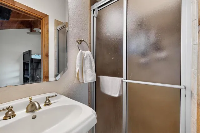 a bathroom with a sink a toilet and mirror