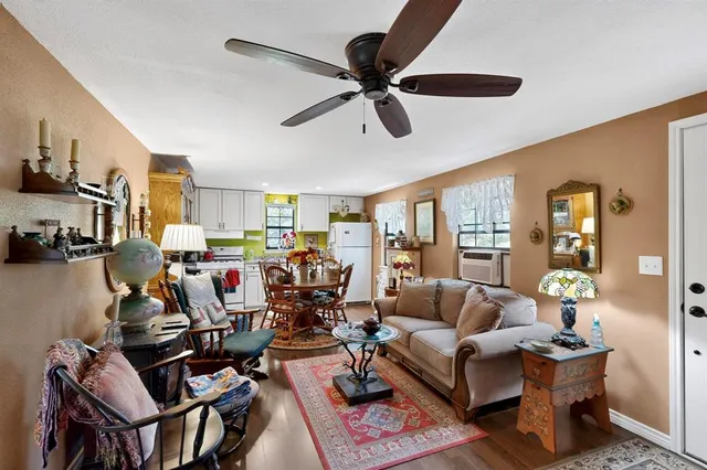 a kitchen with stainless steel appliances a refrigerator a sink a stove and white cabinets