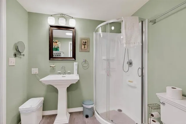 a bathroom with a granite countertop sink a toilet and a mirror