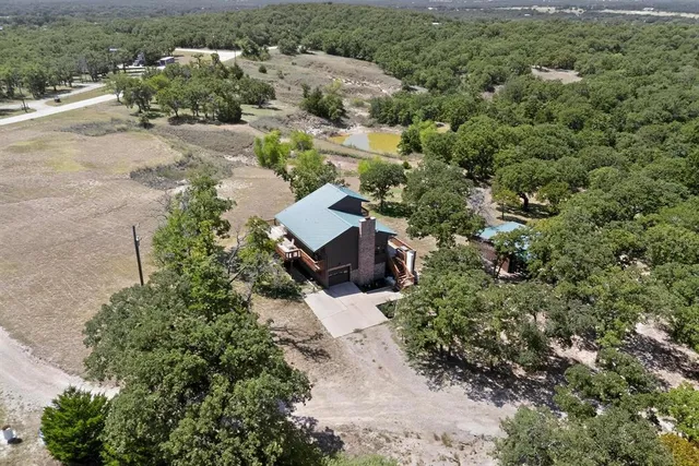 an aerial view of a house with a yard