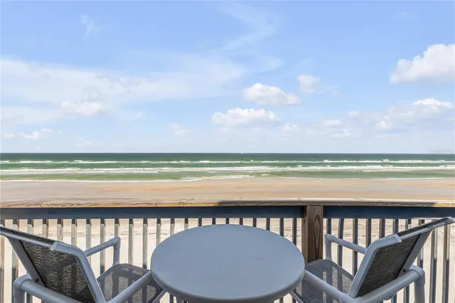 a large white kitchen with a large window and stainless steel appliances
