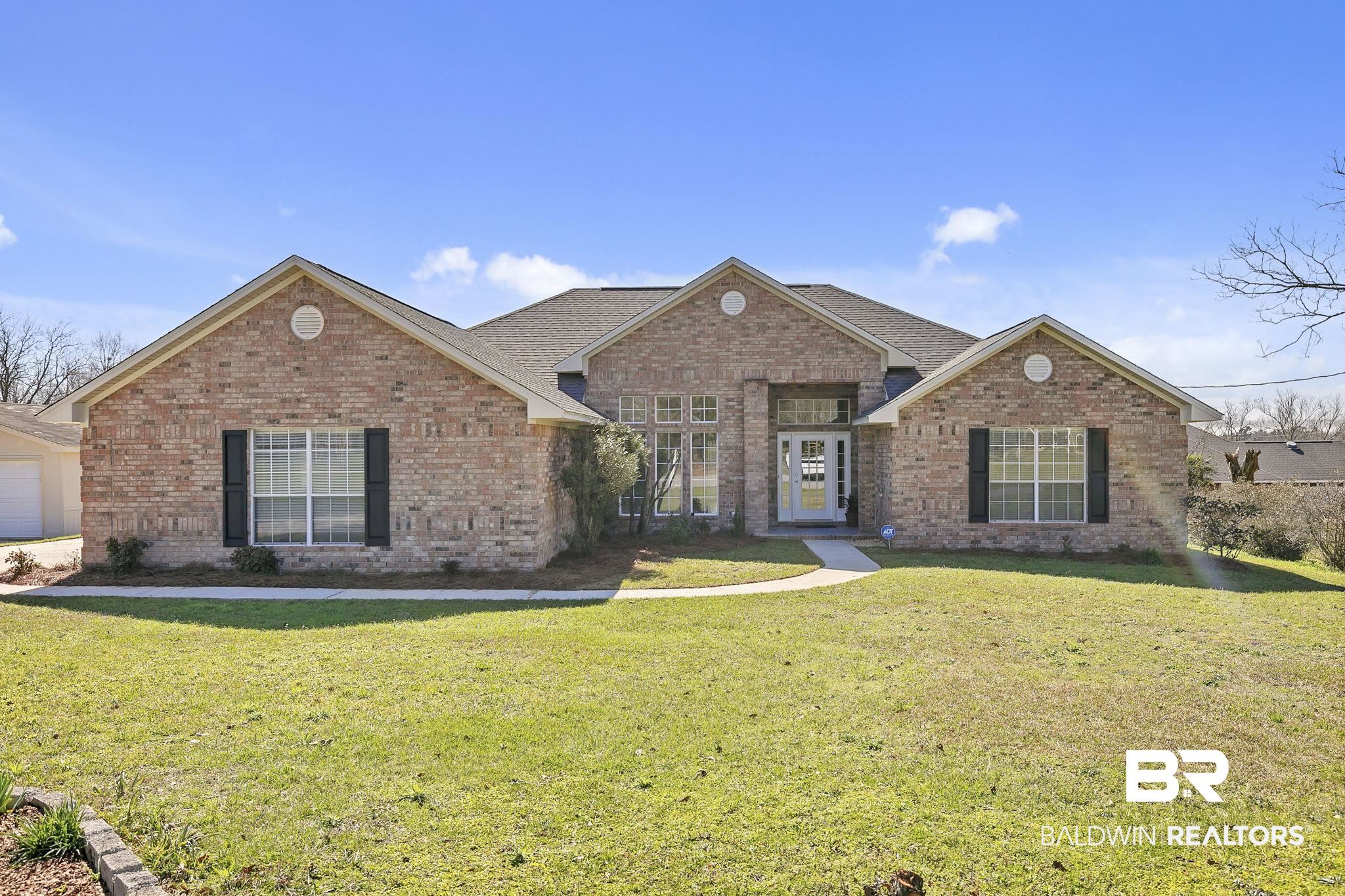 10238 Grove Drive Fairhope, AL 36532 - Photo 1 of 39 View of front facade with a front lawn and brick siding