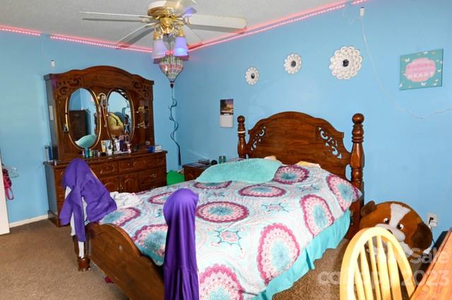 336 Mt Tabor Church Road Union, SC 29379 - Photo 28 of 37 a bedroom with a bed and a chandelier