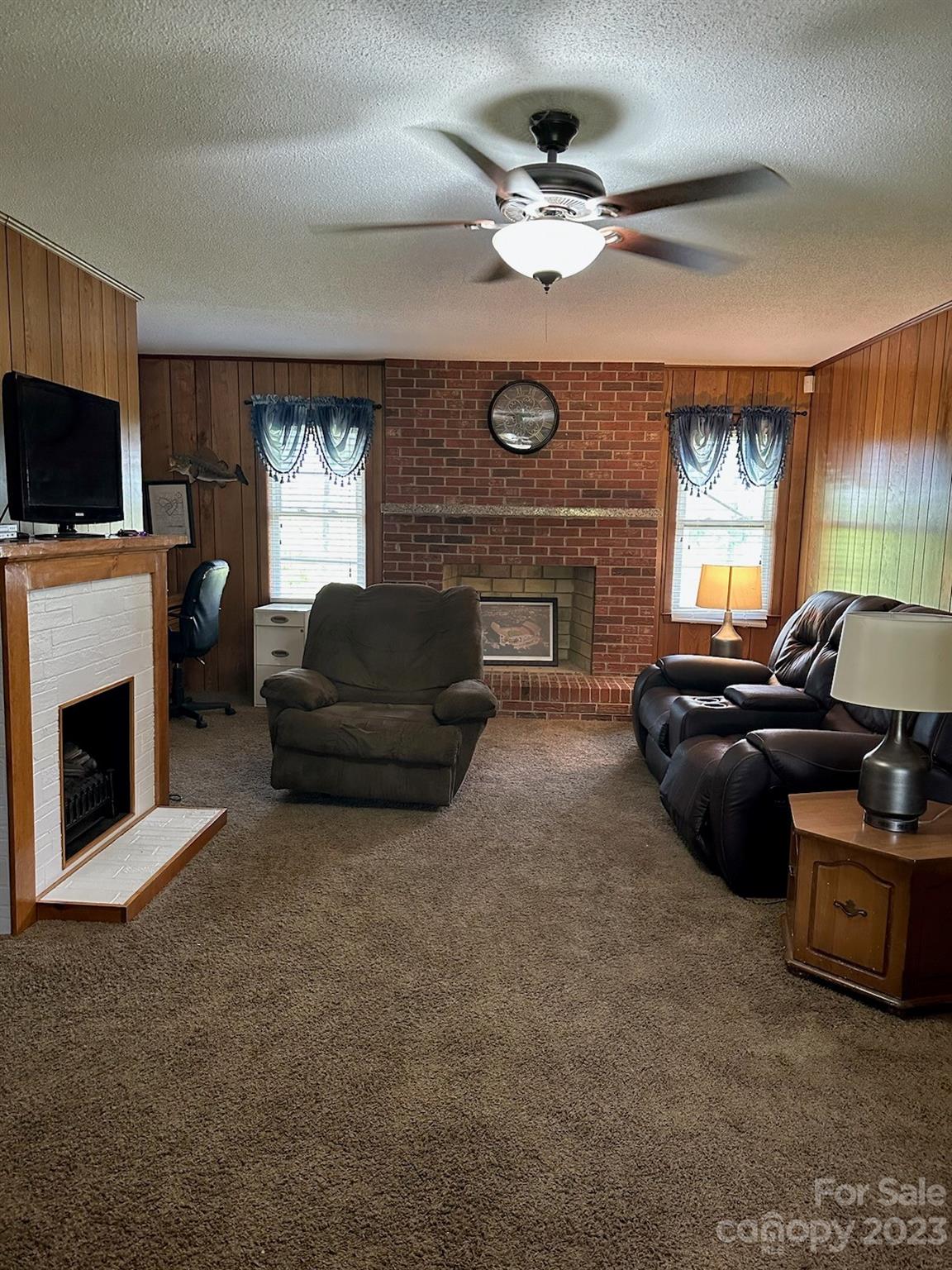 336 Mt Tabor Church Road Union, SC 29379 - Photo 9 of 37 a living room with furniture a fireplace and a flat screen tv