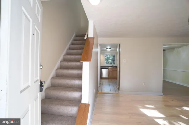 a view of entryway and hall with wooden floor
