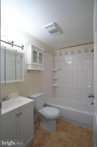 a bathroom with a toilet a sink and bathtub