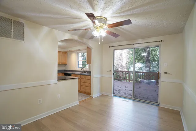 a view of an empty room with a kitchen