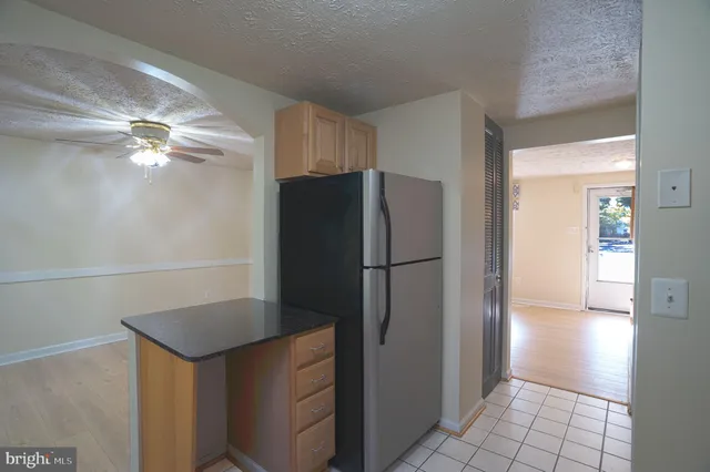 a kitchen with metallic refrigerator freezer and a dishwasher