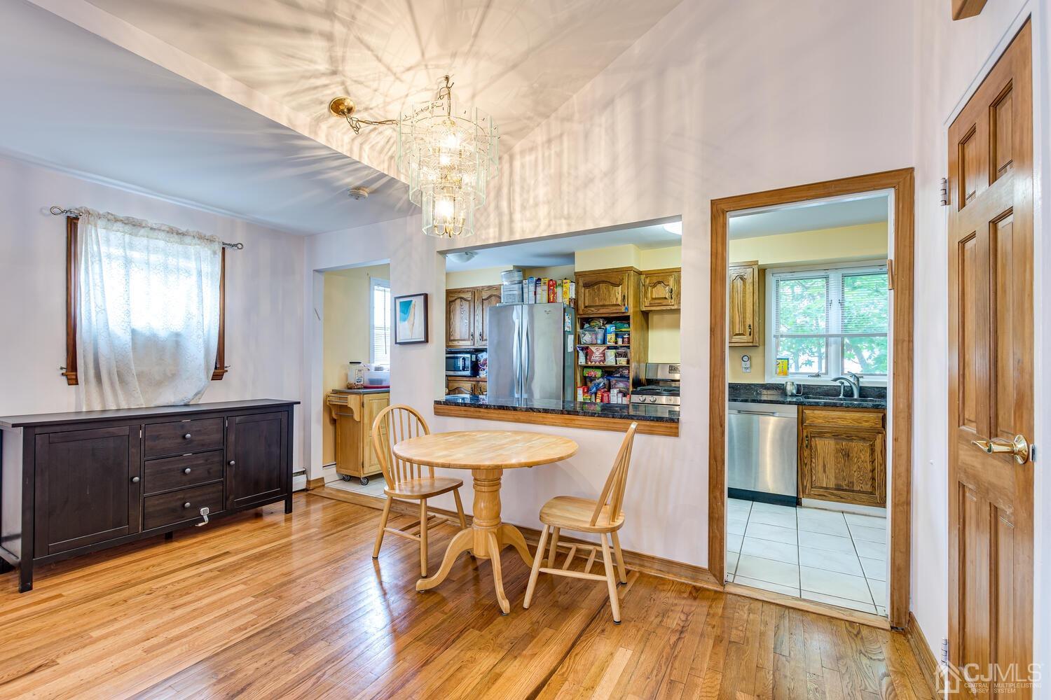 41 Partch Place Edison, NJ 08817 - Photo 9 of 28 a dining room with furniture and wooden floor