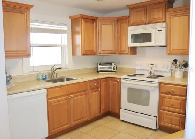 a kitchen with stainless steel appliances granite countertop white cabinets sink and a granite counter top