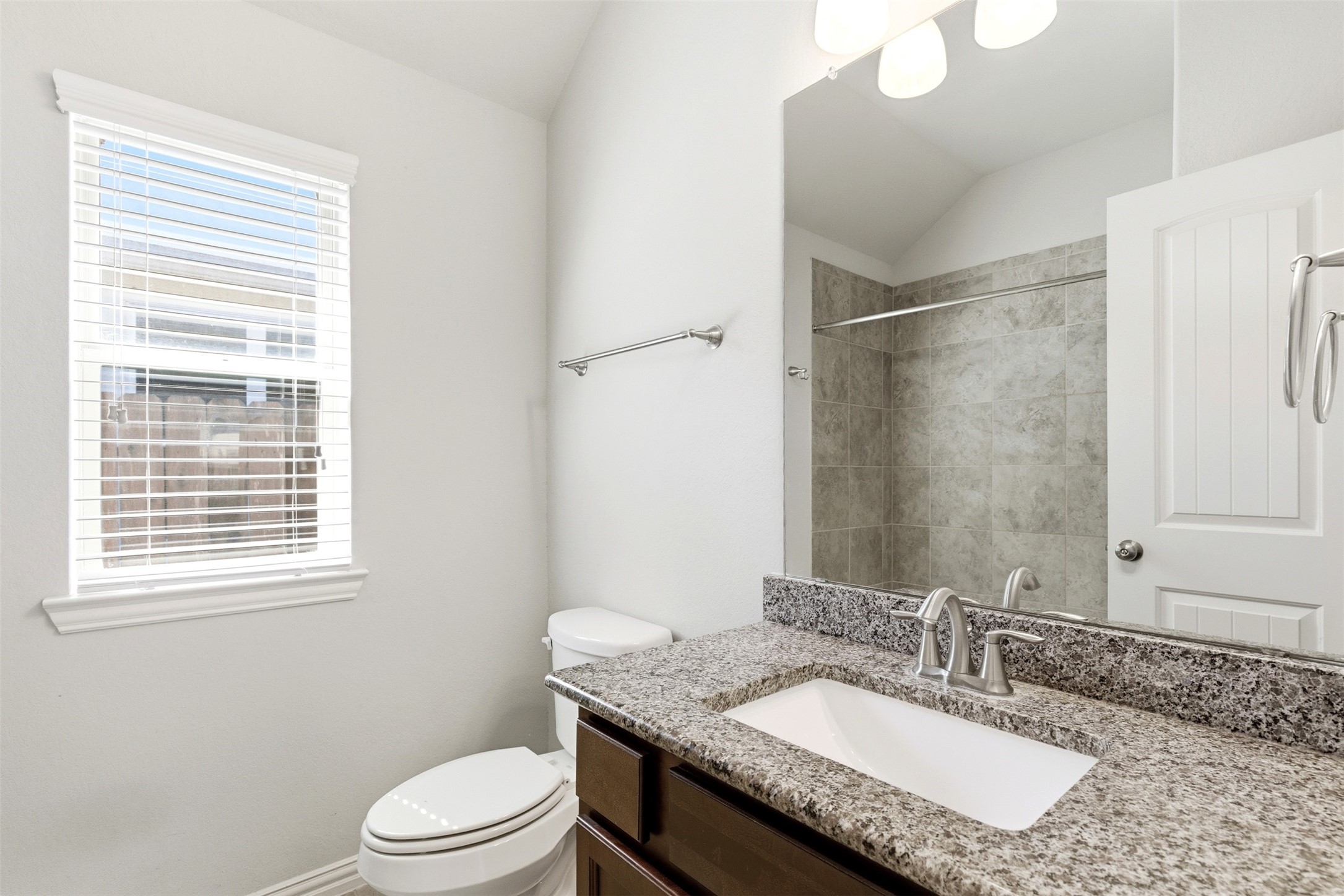 4507 Barnstone Ridge Lane Rosharon, TX 77583 - Photo 18 of 23 a bathroom with a granite countertop sink toilet a mirror and shower