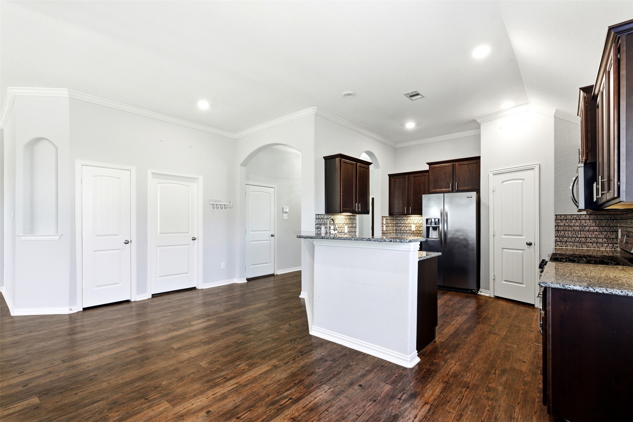 4507 Barnstone Ridge Lane Rosharon, TX 77583 - Photo 7 of 23 a kitchen with stainless steel appliances kitchen island wooden floors and refrigerator