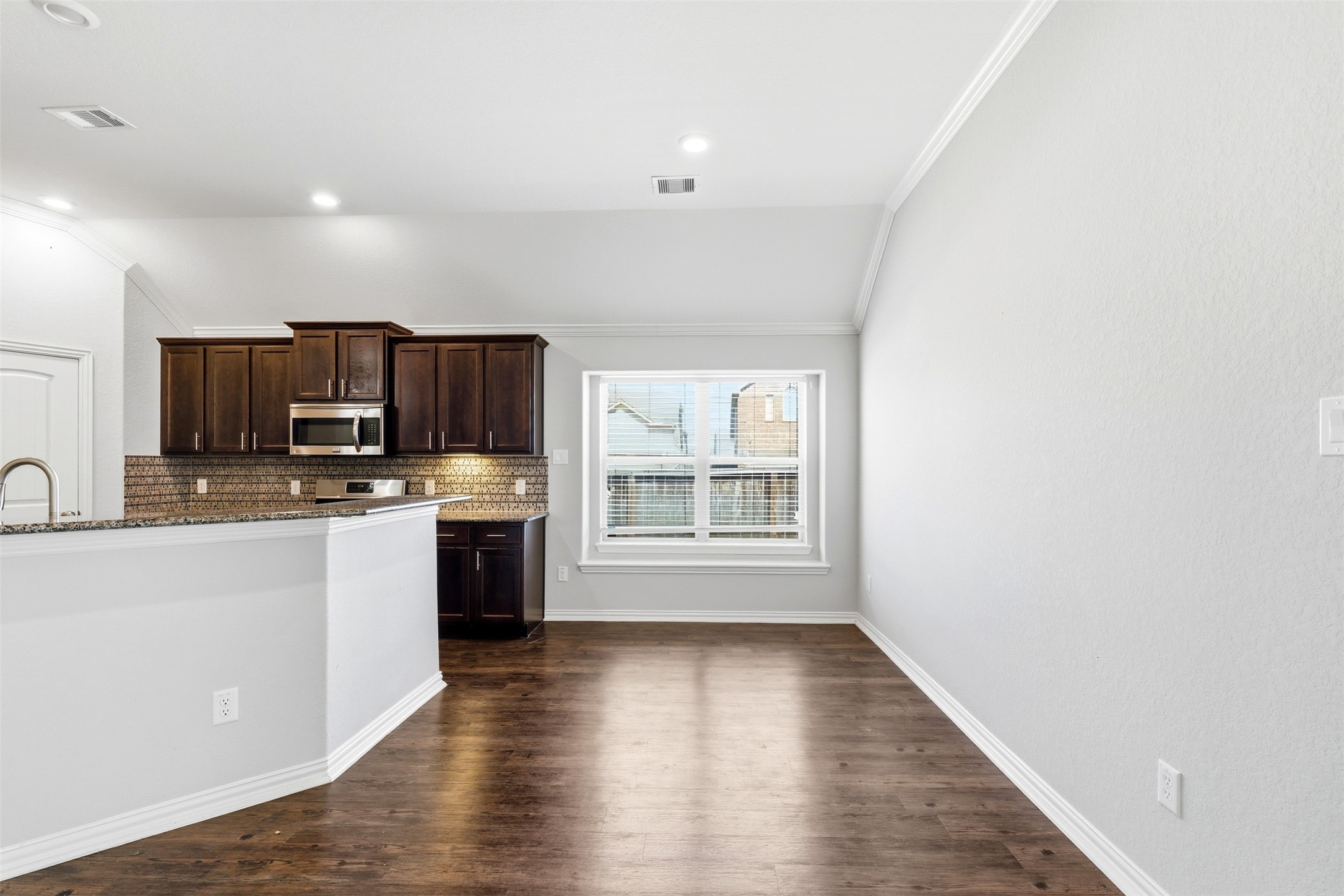 4507 Barnstone Ridge Lane Rosharon, TX 77583 - Photo 8 of 23 a kitchen with stainless steel appliances a stove top oven a sink dishwasher a refrigerator and white cabinets with wooden floor