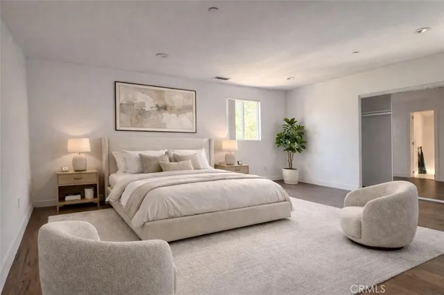 a spacious bedroom with a bed and window