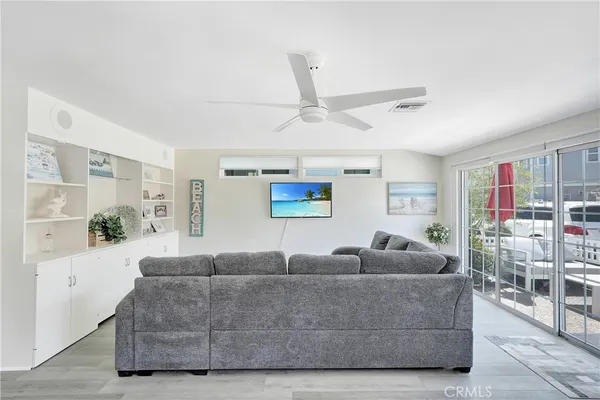 a living room with furniture and a ceiling fan