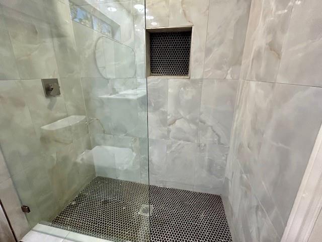 17119 Upper Bay Road Addison, TX 75001 - Photo 15 of 29 a bathroom with a sink and a shower