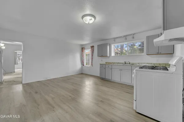 a kitchen with granite countertop a stove and cabinets