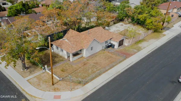 an aerial view of a house with a yard