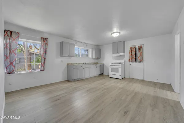 a view of a kitchen with microwave and cabinets