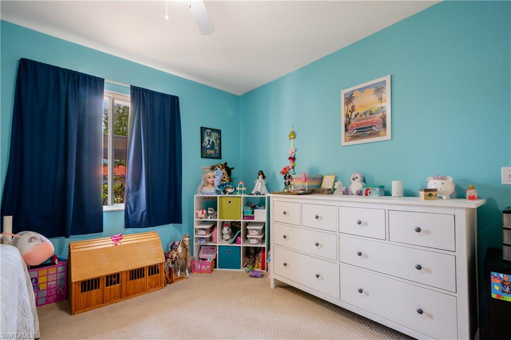 8264 Key Royal Circle, Unit 813 Naples, FL 34119 - Photo 17 of 21 a bedroom with furniture and a dresser