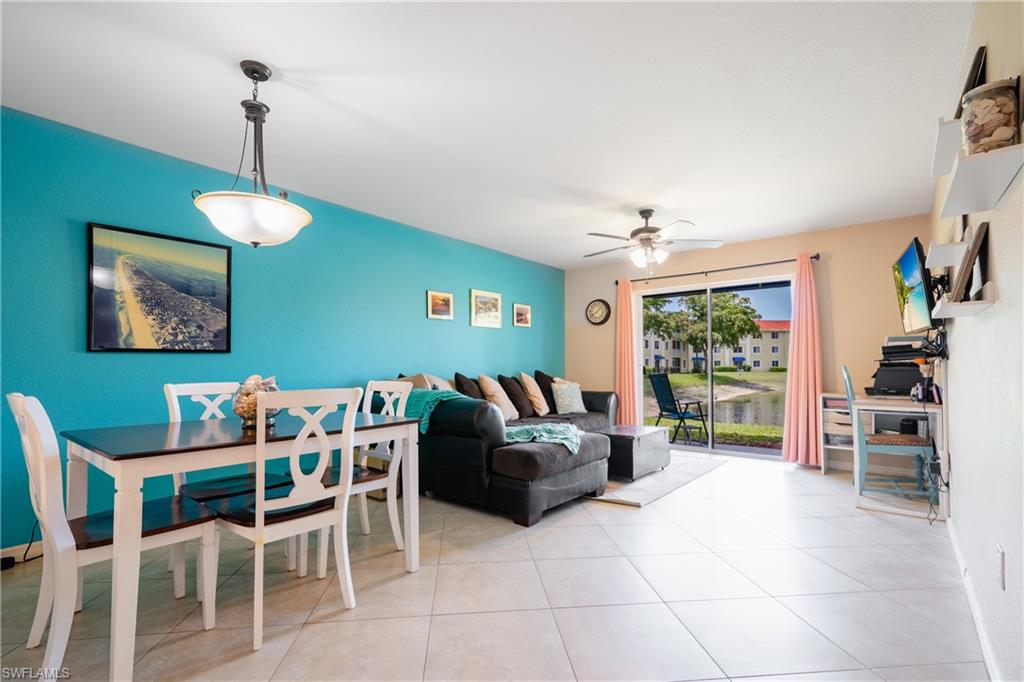 8264 Key Royal Circle, Unit 813 Naples, FL 34119 - Photo 5 of 21 a living room with furniture a window and a chandelier