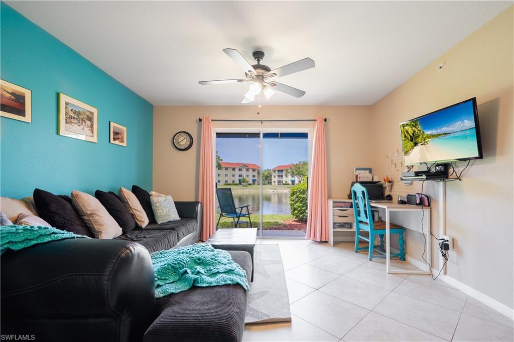 8264 Key Royal Circle, Unit 813 Naples, FL 34119 - Photo 6 of 21 a living room with furniture a window and a flat screen tv