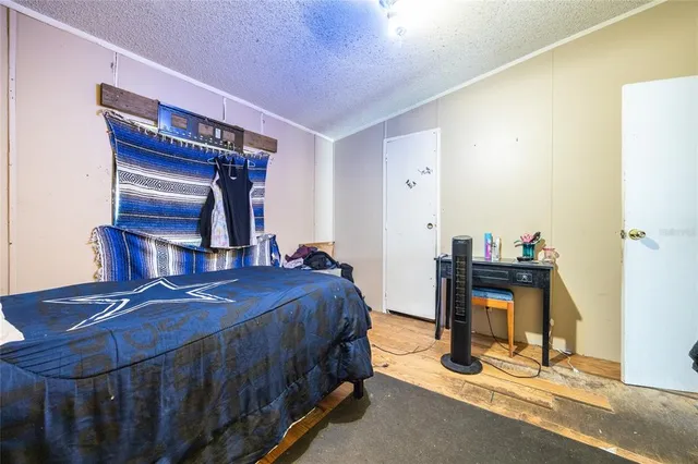 a bedroom with furniture and a wooden floor