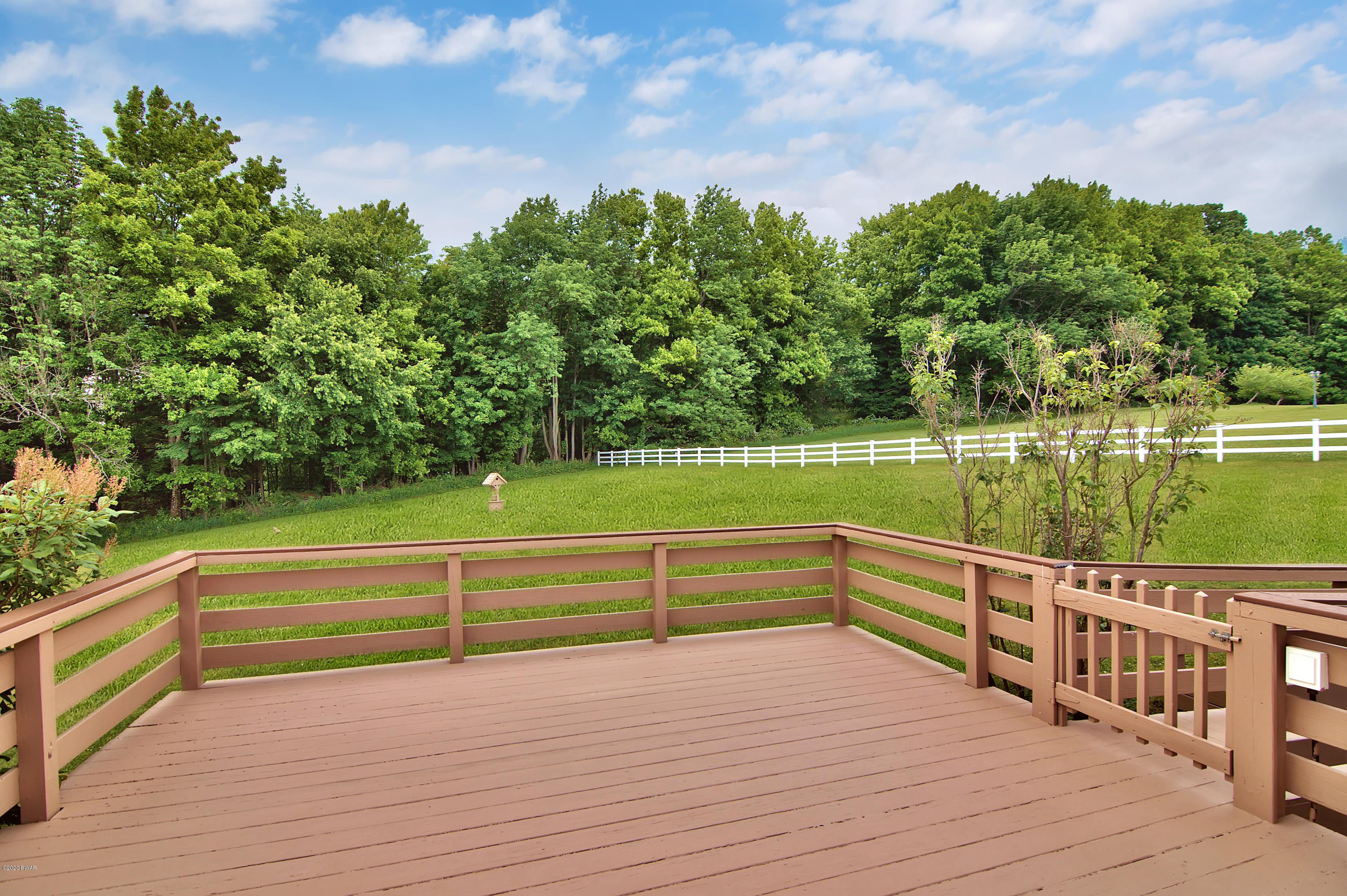63 Callapoose Road Moscow, PA 18444 - Photo 7 of 73 a view of a terrace with yard and lake view in back