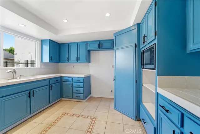 a kitchen with granite countertop wooden cabinets and stainless steel appliances