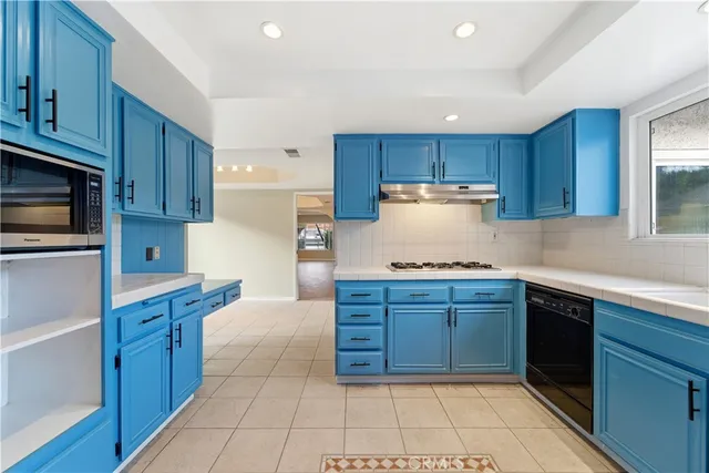a kitchen with cabinets and appliances