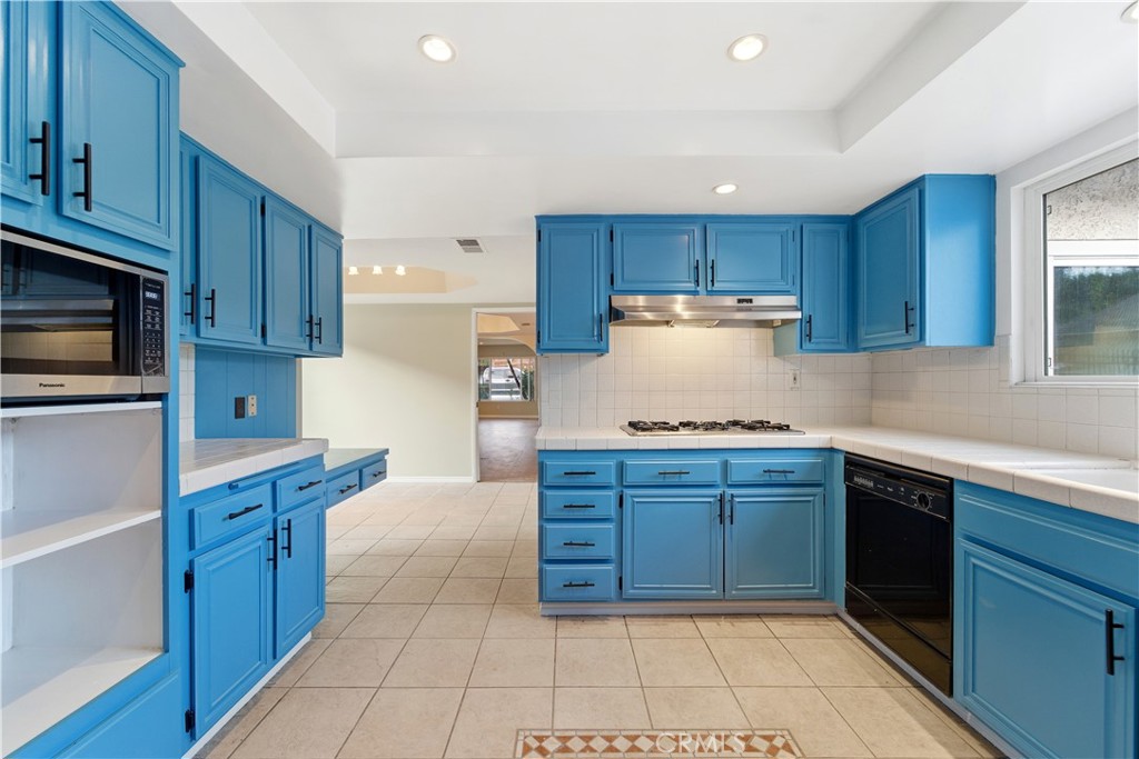 16650 Rinaldi Street Granada Hills, CA 91344 - Photo 14 of 35 a kitchen with granite countertop wooden cabinets and stainless steel appliances