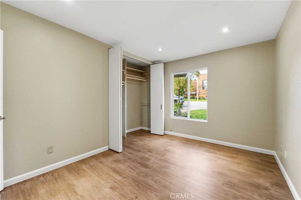16650 Rinaldi Street Granada Hills, CA 91344 - Photo 18 of 35 an empty room with wooden floor and windows