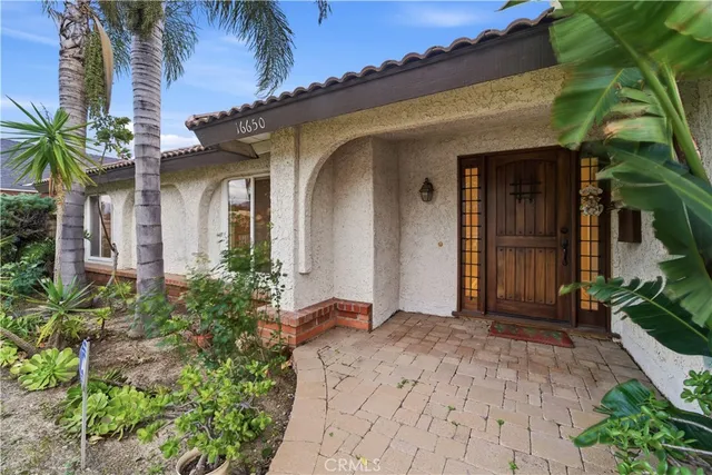 a view of a house with a flower garden