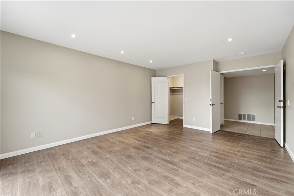 16650 Rinaldi Street Granada Hills, CA 91344 - Photo 26 of 35 an empty room with wooden floor & windows