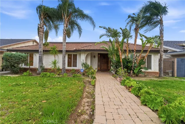 a view of a house with potted plants