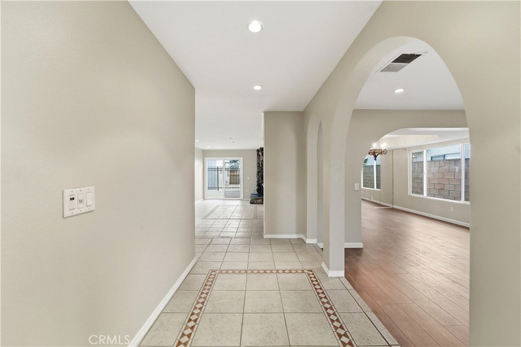 16650 Rinaldi Street Granada Hills, CA 91344 - Photo 4 of 35 a view of a hallway with wooden floor and staircase