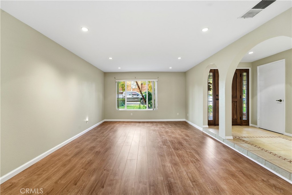 16650 Rinaldi Street Granada Hills, CA 91344 - Photo 5 of 35 an empty room with wooden floor and windows